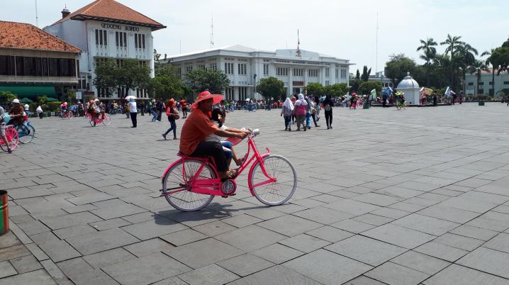 Man on bike at Fatahillah Square in front of former Batavia City Hall. Photo Remco Vermeulen